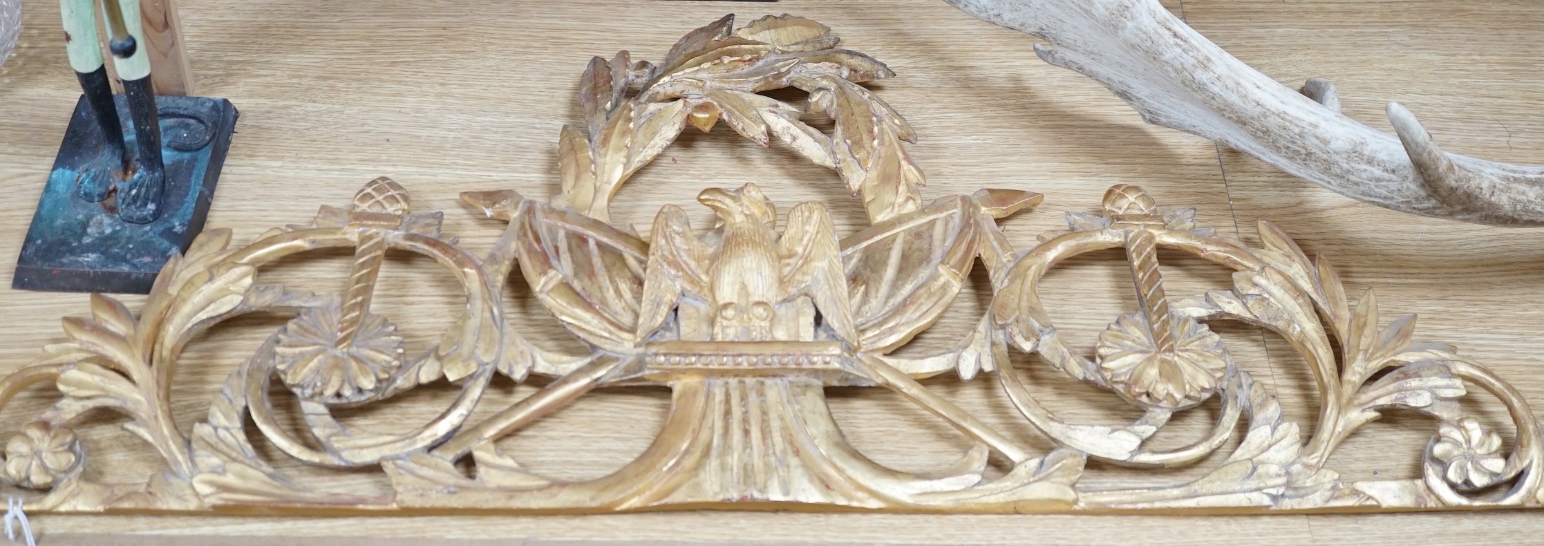 A 19th century ornate carved giltwood eagle surmount, 39cms high x 92cms wide